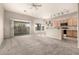 Bright living room with carpet, ceiling fan, and sliding glass doors to the backyard at 689 E Stottler Dr, Gilbert, AZ 85296