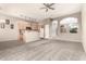 Open concept living room with kitchen, carpet, tile, and arched doorway at 689 E Stottler Dr, Gilbert, AZ 85296