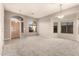 Spacious living room with carpet, natural light, and a welcoming entrance featuring arched windows at 689 E Stottler Dr, Gilbert, AZ 85296
