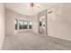 Spacious main bedroom with carpet, ceiling fan, and large windows with natural light at 689 E Stottler Dr, Gilbert, AZ 85296