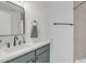 Bathroom featuring white countertops, green cabinetry, and a framed mirror above the sink at 745 N Dobson Rd # 144, Mesa, AZ 85201