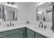 Double sink vanity featuring a white countertop, black hardware, and dark green cabinetry at 745 N Dobson Rd # 144, Mesa, AZ 85201