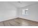 This bedroom features a ceiling fan, a window with blinds and light colored wood-look flooring at 745 N Dobson Rd # 144, Mesa, AZ 85201