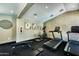 Well-lit gym featuring modern treadmills, elliptical, and weight-lifting bench with art at 745 N Dobson Rd # 144, Mesa, AZ 85201