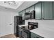Contemporary kitchen features black appliances and quartz countertops at 745 N Dobson Rd # 144, Mesa, AZ 85201
