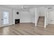 Bright living room featuring wood floors, a fireplace, and a ceiling fan at 745 N Dobson Rd # 144, Mesa, AZ 85201