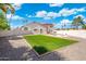 Large backyard with artificial turf area, providing ample space for outdoor activities and enjoyment at 7503 W Julie Dr, Glendale, AZ 85308