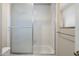 Bathroom with a frosted glass shower door and tile surround, with silver hardware and towel rack at 7503 W Julie Dr, Glendale, AZ 85308