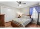 Cozy bedroom featuring hardwood floors, a ceiling fan, and a well-sized closet at 7503 W Julie Dr, Glendale, AZ 85308