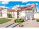 Inviting single-story home featuring a manicured yard, red tiled roof, and solar panels at 7503 W Julie Dr, Glendale, AZ 85308