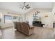 Comfortable living room with tile floors, neutral walls, large windows, and a cozy recliner at 7503 W Julie Dr, Glendale, AZ 85308