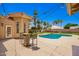Backyard features a beautiful pool, patio, mature trees and lovely landscaping at 7722 W Libby St, Glendale, AZ 85308