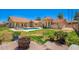 Wide backyard with a pool, grassy area, and lush landscaping offers privacy and space at 7722 W Libby St, Glendale, AZ 85308