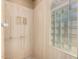 Close up of a corner of the bathroom featuring a tiled wall and a window made of glass blocks at 7722 W Libby St, Glendale, AZ 85308