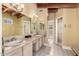 Bathroom featuring tile flooring, double sinks, and a vanity with tile countertop at 7722 W Libby St, Glendale, AZ 85308