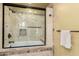 Elegant bathroom featuring a tiled shower with glass enclosure and stylish fixtures at 7722 W Libby St, Glendale, AZ 85308