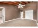 Bedroom featuring vaulted ceilings, a fan, and an entrance to the bathroom, and a large double door closet at 7722 W Libby St, Glendale, AZ 85308