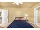 Bedroom with a ceiling fan, adjoining bathroom and a tranquil ambiance at 7722 W Libby St, Glendale, AZ 85308