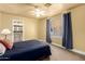 Cozy bedroom featuring a ceiling fan, natural light from the window, and an adjoining bathroom at 7722 W Libby St, Glendale, AZ 85308