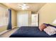 Inviting bedroom featuring a window with blinds, a ceiling fan, and a spacious closet at 7722 W Libby St, Glendale, AZ 85308