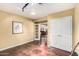 Bonus room featuring hardwood floors, neutral walls, and access to adjacent areas at 7722 W Libby St, Glendale, AZ 85308