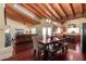 Bright dining area open to kitchen with beam ceilings and skylights at 7722 W Libby St, Glendale, AZ 85308