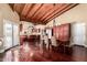 Open-concept dining area with wood floors, wood-beam ceilings, and abundant natural light at 7722 W Libby St, Glendale, AZ 85308