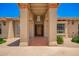 Inviting front porch with a well-lit entryway and well-maintained landscaping at 7722 W Libby St, Glendale, AZ 85308