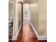 Hallway with dark wood floors that connect the toilet and the other rooms of the home at 7722 W Libby St, Glendale, AZ 85308