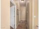 A hallway with tile floors connecting various rooms in the house at 7722 W Libby St, Glendale, AZ 85308