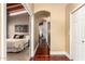 Hallway leads to bedroom with hardwood floors and arched entry at 7722 W Libby St, Glendale, AZ 85308
