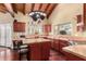 Well-lit kitchen features a center island with a decorative pot rack overhead at 7722 W Libby St, Glendale, AZ 85308