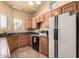 Bright kitchen with wood cabinets, granite countertops, and tile flooring at 7722 W Libby St, Glendale, AZ 85308