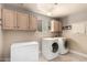 Laundry room with washer, dryer, freezer, and ample cabinet space at 7722 W Libby St, Glendale, AZ 85308