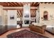 Expansive living room featuring a painted brick fireplace and wood beam ceilings at 7722 W Libby St, Glendale, AZ 85308