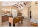 Spacious living room features wood beams, tile flooring, and plenty of natural light at 7722 W Libby St, Glendale, AZ 85308