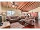Inviting living room with a beamed ceiling and cozy, comfortable sofas at 7722 W Libby St, Glendale, AZ 85308