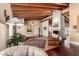 Spacious living room with wood beam ceilings and a striking fireplace at 7722 W Libby St, Glendale, AZ 85308
