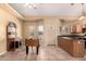 Open living area features a foosball table, neutral paint, and tile flooring at 7722 W Libby St, Glendale, AZ 85308