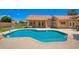 Backyard pool with large deck, a built-in waterfall, and a basketball hoop in a well-maintained landscaped backyard at 7722 W Libby St, Glendale, AZ 85308