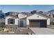 Charming single-story home boasts a stucco exterior, desert landscaping, and stunning mountain views in the background at 9357 S Mineros Dr, Apache Junction, AZ 85120