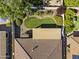 Aerial view of a landscaped backyard, including a patio, seating area, a small lawn, and a blooming tree at 10749 W Lariat Ln, Peoria, AZ 85383