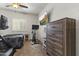 Bedroom with a ceiling fan, a TV, a dresser, and a bed with exercise equipment in front of the bed at 10749 W Lariat Ln, Peoria, AZ 85383