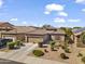 Charming single-story home with desert landscaping, a two-car garage, and tiled roof in a vibrant desert community at 10749 W Lariat Ln, Peoria, AZ 85383
