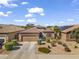 Lovely single-story home with desert landscaping, two-car garage, and tiled roof on a sunny day in a desert community at 10749 W Lariat Ln, Peoria, AZ 85383