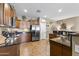 Beautiful kitchen offers stainless steel appliances, granite counters, and a neutral color palette at 10749 W Lariat Ln, Peoria, AZ 85383