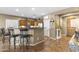 Open-concept kitchen featuring granite countertops, stainless steel appliances, and a breakfast bar at 10749 W Lariat Ln, Peoria, AZ 85383
