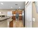 Well-lit kitchen boasts stainless appliances, dark wood cabinets, and updated fixtures at 10749 W Lariat Ln, Peoria, AZ 85383