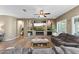 Comfortable living room features a fireplace, ceiling fan, and built-in shelving for style and functionality at 10749 W Lariat Ln, Peoria, AZ 85383