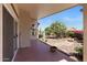 Comfortable covered patio space looking out to the private and serene backyard with attractive desert landscaping at 10936 N Ventana W Dr, Peoria, AZ 85373